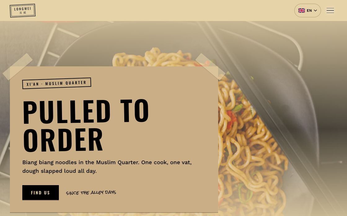 Wide fried noodles with chilies on a dark tray