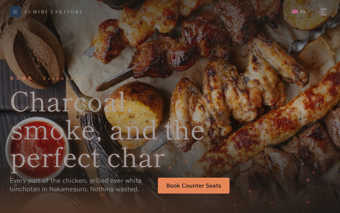 Grilled skewers close up over dark coals